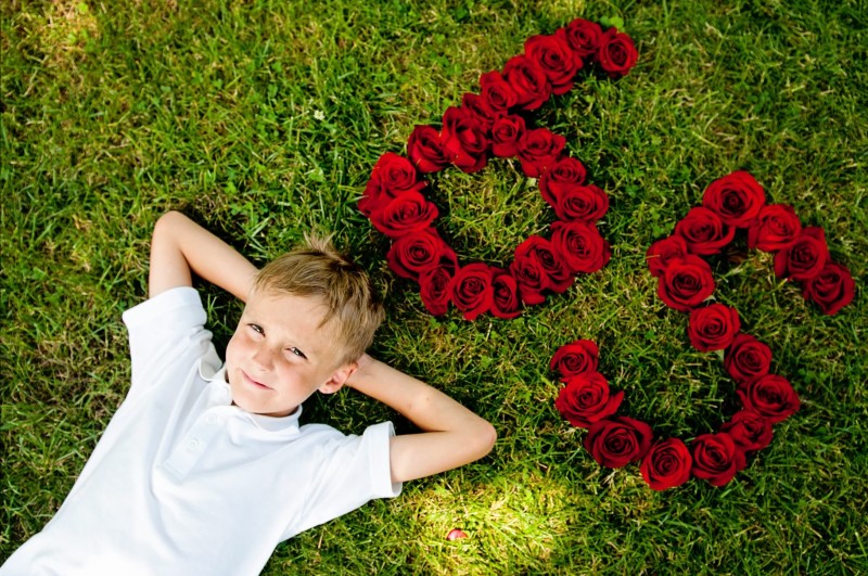 Brayden Walsh lying next to 65 roses, in order to promote his cause.  Photo Credit / Teresa Walsh