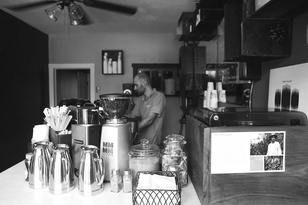 Owner of Café Duet, Daniel Bickart, makes a latte behind the counter of his café.  Photo Credit / Audra Organetti
