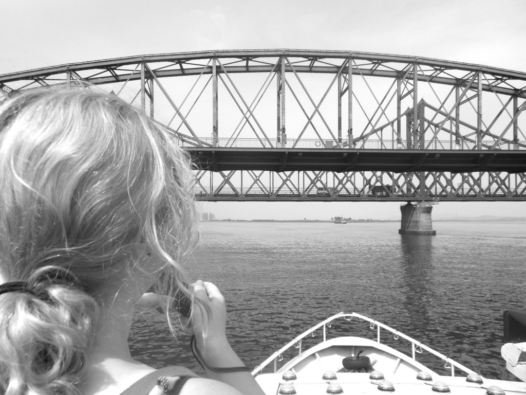 Alumna Dana Reese pauses during her study abroad trip to take a picture of the bridge that connects China and North Korea. Photo Credit / Jamie Reese