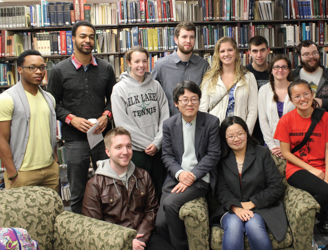 Students pose with celebrated ESU author, Dr. Heon Kim. Photo Credit / Eric Kump