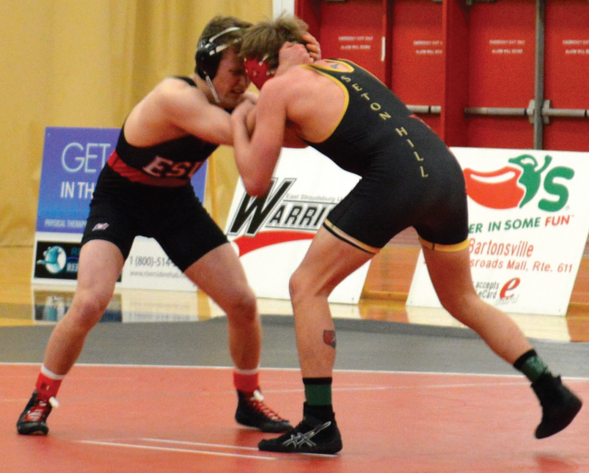 Two wrestlers from ESU and Seton Hill tangle on the mats. Photo Credit / Crystal Smith