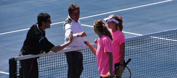 The doubles team of Presby and Bartoli celebrate their win with the coaches. Photo Credit / Ronald Hanaki