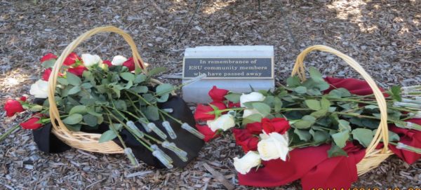 Flowers are laying by a plaque honoring those lost this past year at ESU. Photo Credit / Edita Bardhi