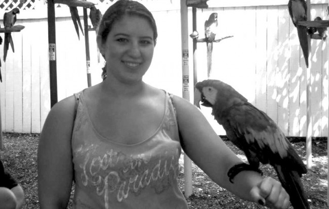 ESU student Briana Magistro holding a macaw at Parrot Mountain in Gatlinburg, Tennessee. Photo Courtesy / Parrot Mountain