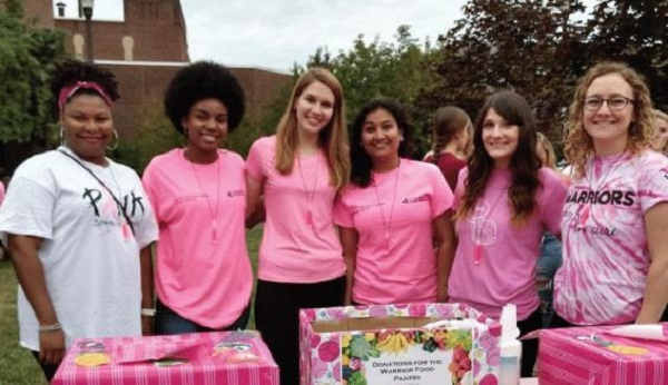 Photo Credit / Laura Jean Null Former and current members of CHO with a booth set up at the last Pink Light Walk.