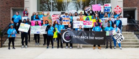 Group photo of Take Back the Night marchers holding signs and chanting