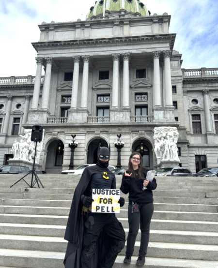Batman and a woman stand at the steps of a capital building