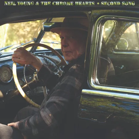 A man sitting in a car looking back over his left shoulder